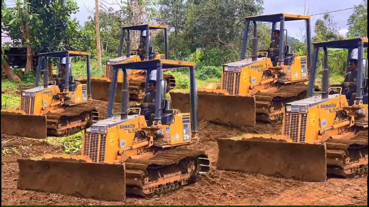 Komatsu Bulldozers work to clear the farmland to make it flat 