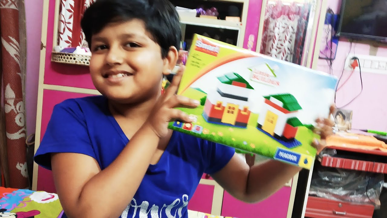 Kids playing with little builder block house/ the house that built asmita