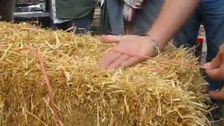 E EARTH   STRAWBALE CONSTRUCTION  ANDREW JOHNSON EXPLAINING HOW TO TIE OFBALE TO DESIRED LENGTH