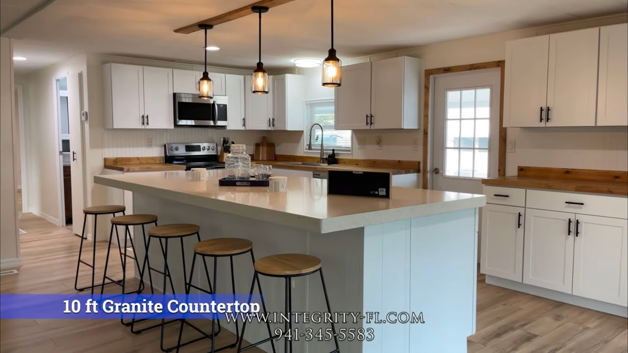 This kitchen has a 10ft granite countertop island w/ electrical outlets