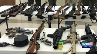 Couple arrested for firing shots that hit homes; 27 guns recovered