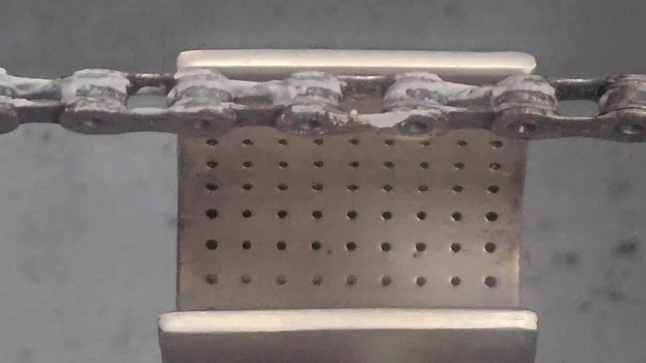 Rewaxing a bicycle chain with Rex Black Magik drip wax