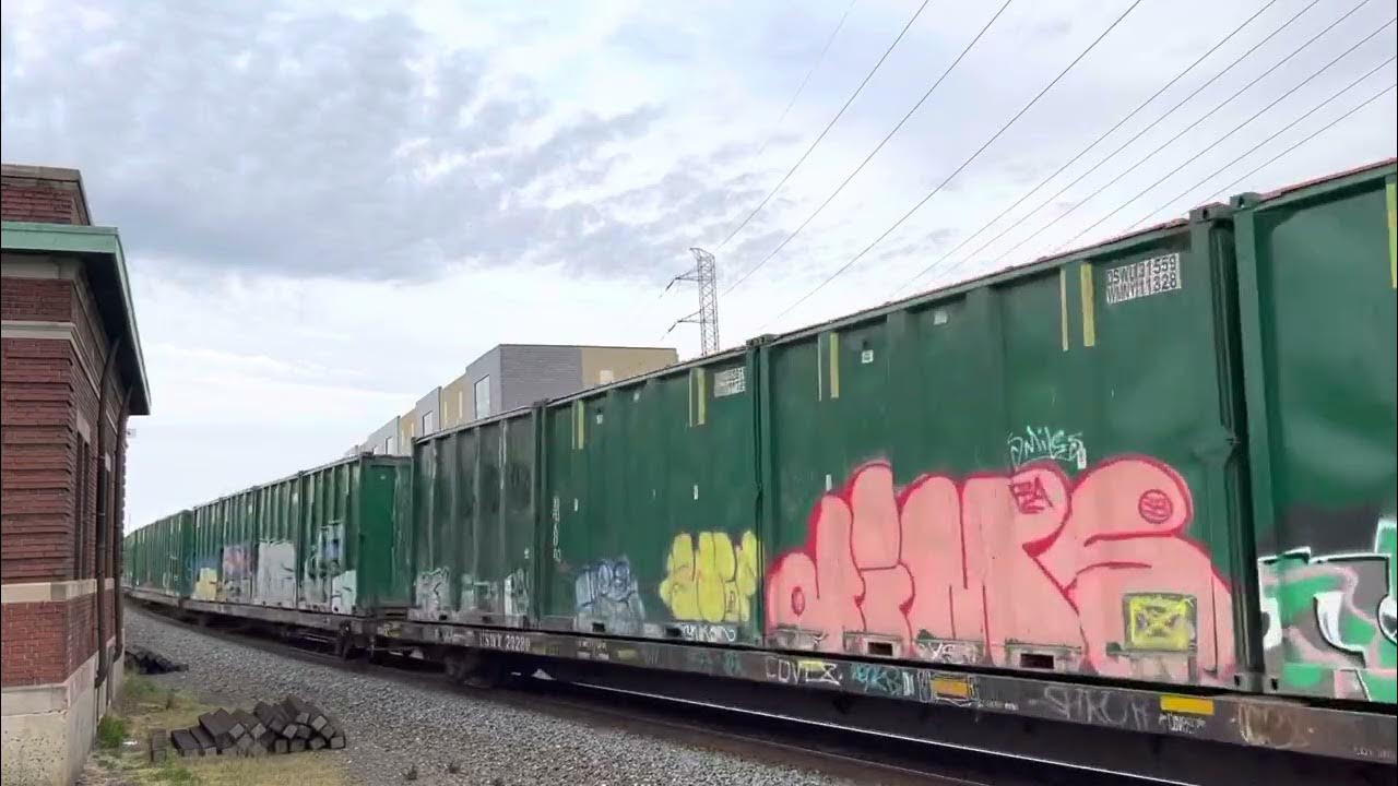 CSX 772 ES44AH leads CSX Q421 with lots of garbage At Bound Brook,NJ