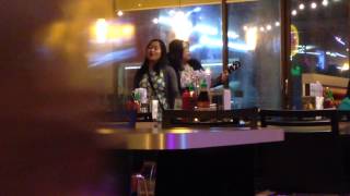 Two girls sing in pho place