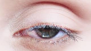 macro close up eye blinking slow motion 120 fps young woman is opening and closing her beautiful eye