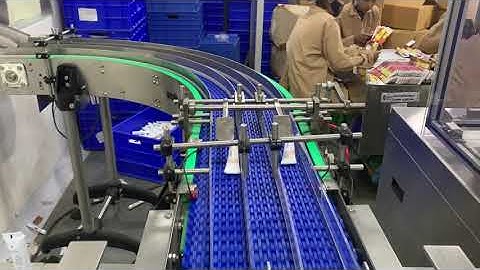 Cartonator with tube transfer link mechanism (tube transfer system)