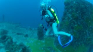 Woman Scuba Diver Exploring Underwater Wreck