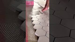 Download Lagu Carefully placing hexagonal tiles onto adhesive for a smooth geometric floor finish MP3 Download Lagu Carefully placing hexagonal tiles onto adhesive for a smooth geometric floor finish MP3