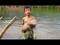 Wandering boy bac demonstrates his skills in using a net to catch giant fish in a large stream