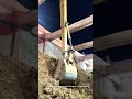 Long Reach Excavator Working at a Nighttime Construction Site