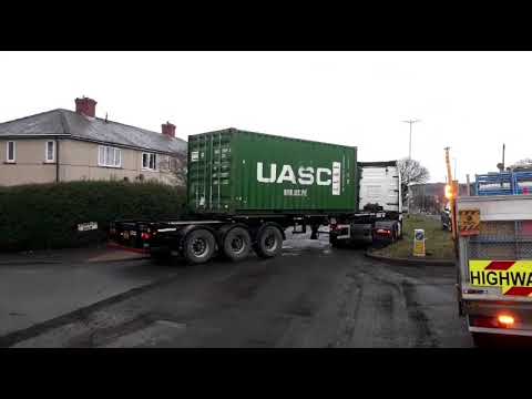 truck driver ignored the Road Ahead Closed signs and comes to a sticky corner.