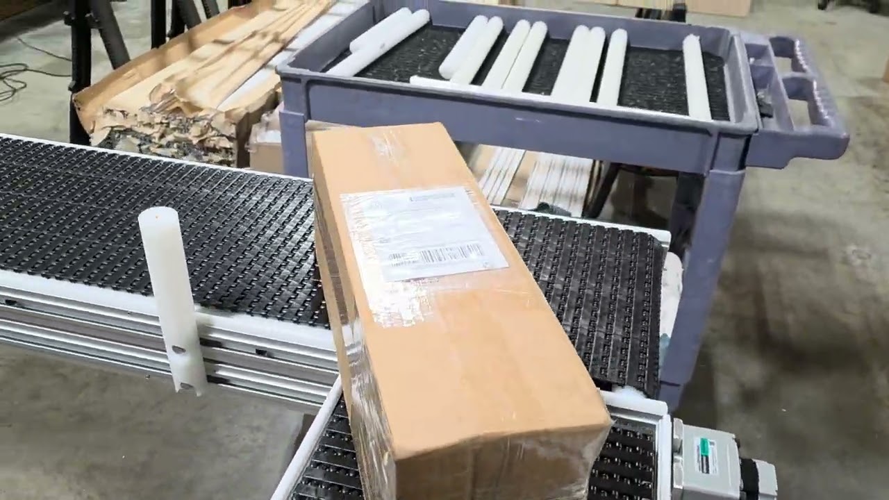 Conveyor corner turn with downstream bump and guide rails.