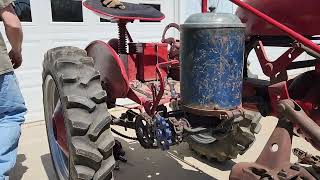 Farmall Cub attaching planter and hillers.
