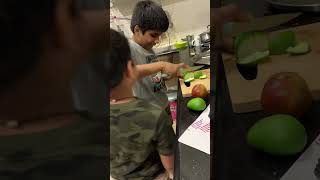 Me and my cousin trying to cut a Mango!! We did it!!