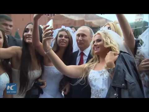 Wow! Putin mobbed by models in wedding dresses