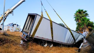 Rotators winch a trailer full of medical supplies that flew off the freeway