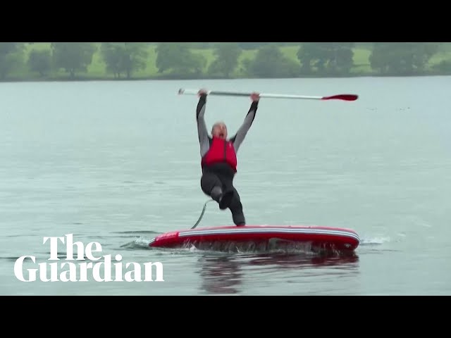 Liberal Democrat leader Ed Davey slips off paddleboard into lake class=