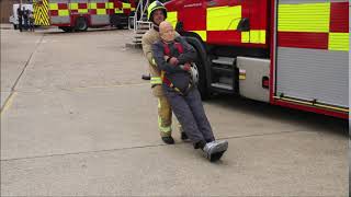 Fire fighter practising the 75kg dummy drag challenge using a mannequin-man rescue dummy mannequin