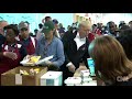 Trump visits with Harvey victims, serves food