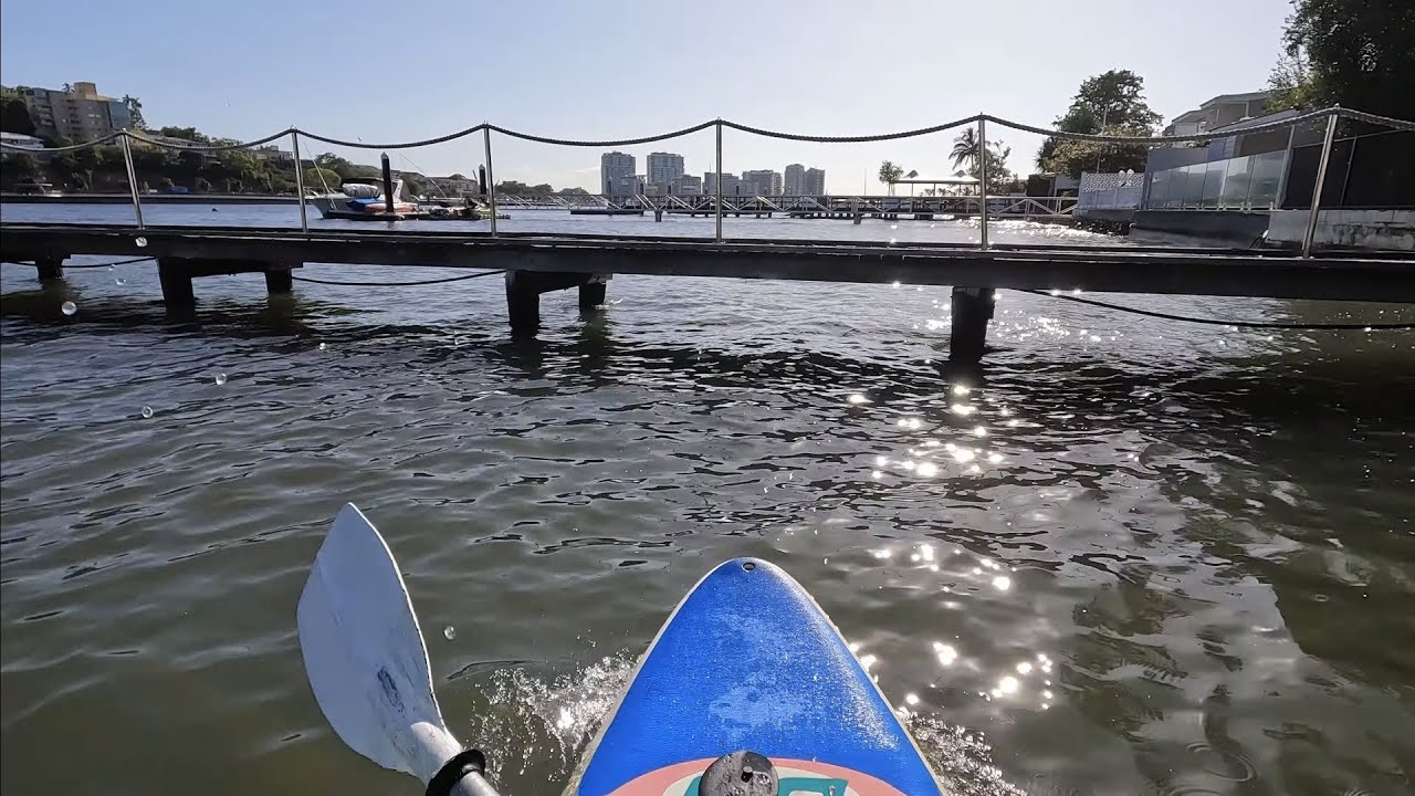 Paddling under Bulimba's high tide jetties