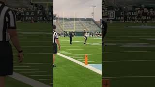 Tyler Shough warms up with running backs at Saints open practice