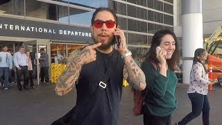 dave navarro and girlfriend have a conference cell phone chat as they arrive in la