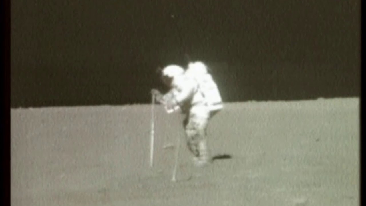 Astronaut Hammers Pole During Moonwalk