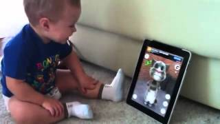 baby talks with cat on iPad