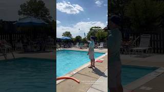 Outdoor swimming pool open for summer scenes, playing catch with ball and water lacrosse scoop …