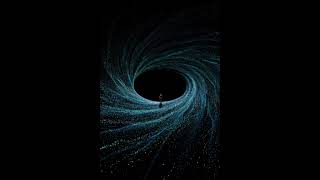 The teal and blue dots flow in continuous concentric rings around the black oval
