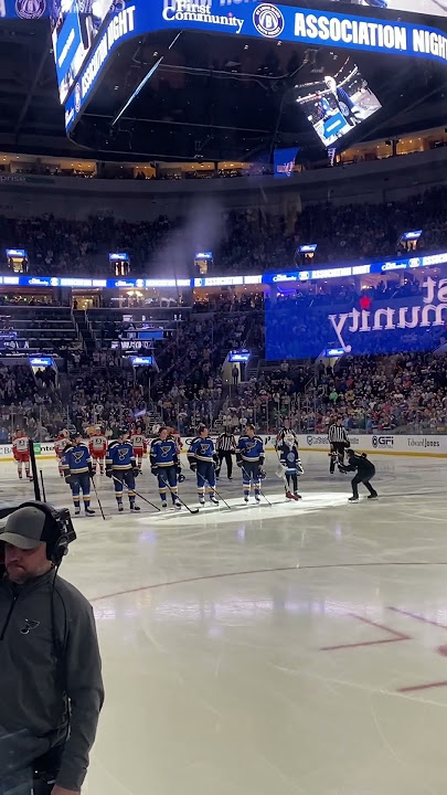 An aspiring goalie joins Blues captain, Brayden Schenn, for natl anthem at start of his 1000th game