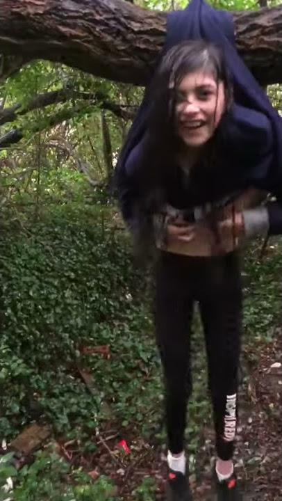 Girl tries to show off while sitting on a tree branch and ends up getting stuck