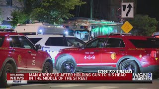 Man arrested after holding gun to his head in middle of street