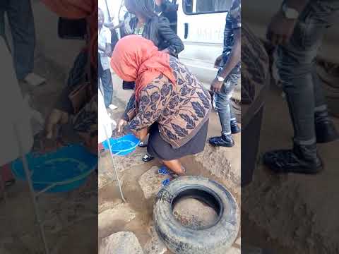 People washing their hands before boarding a taxi at Bweyogerere taxi stage to prevent Coronavirus