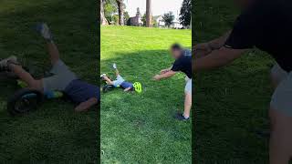 Boy rides bike down grass hill then falls forward and faceplants in scorpion position (Slow motion)