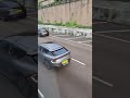 A grey tesla was driving on a Hong Kong Highway