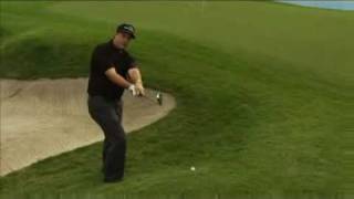 Phil Mickelson does a backwards shot