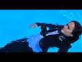 Beautiful lady in suit and blue shirt, got wet fully clothed in swimming pool