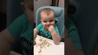 Guy throws American cheese at baby boy seated in high chair