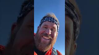 Man Witnessing Sunrise and Eruption During Two-Volcano Climb