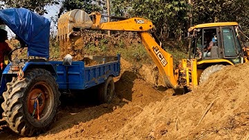 Backhoe Machine 3DX Loading Deep-Seated Soil Into A Tractor