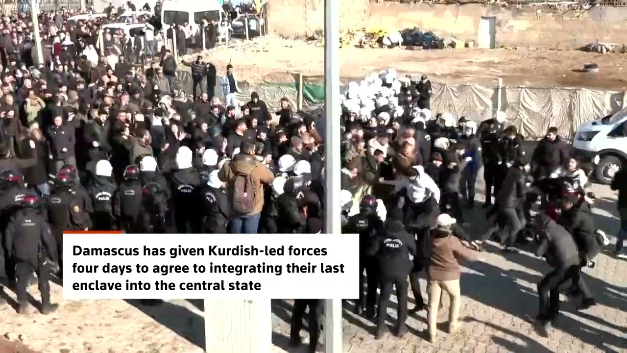 Pro-Kurdish protesters in Turkey cross border wall into Syria | REUTERS