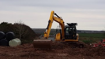 JCB JS130 clearing wet ground