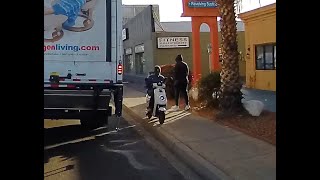 Idiot riding a scooter the wrong way on the sidewalk