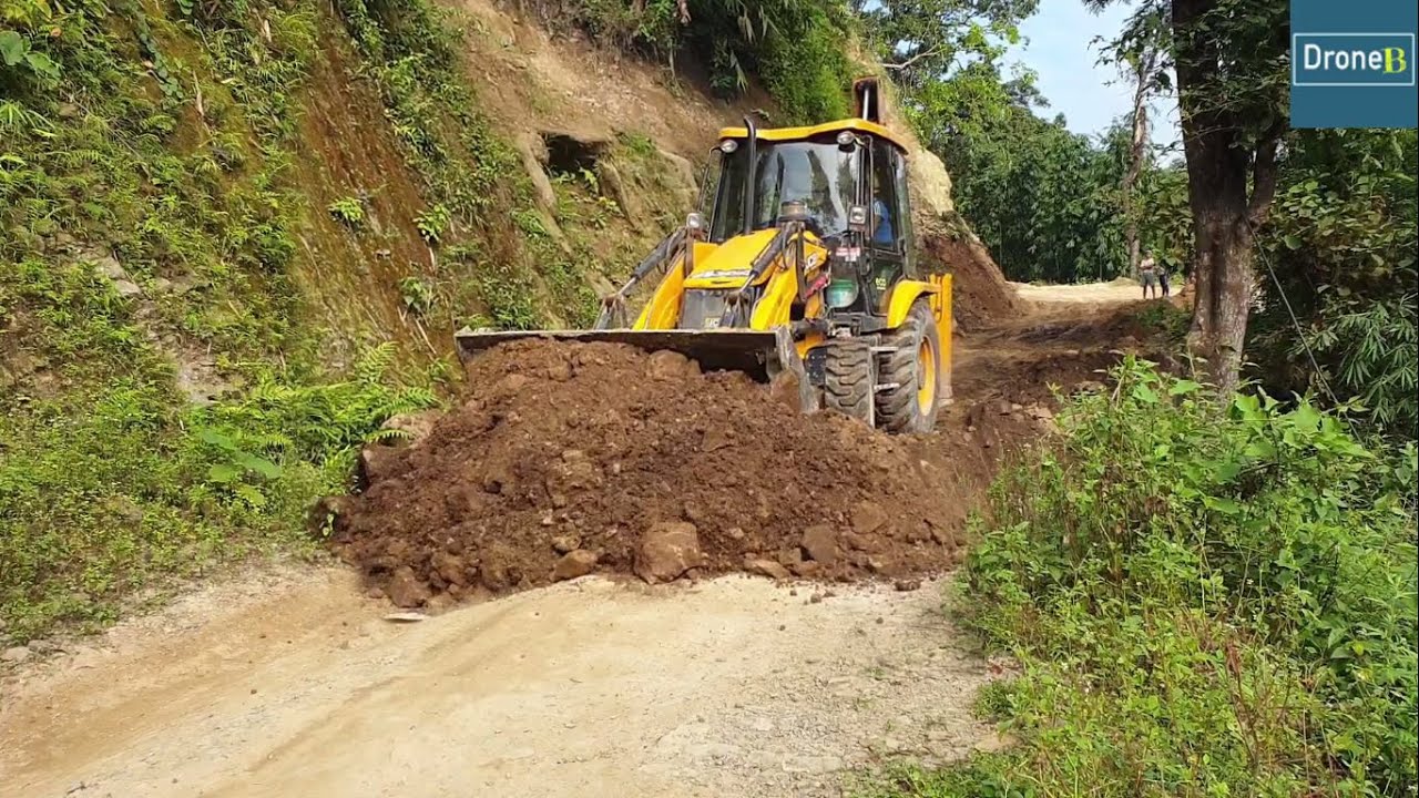 JCB ecoXcellence Backhoe Loader-Leveling Hilly Road with Ruts