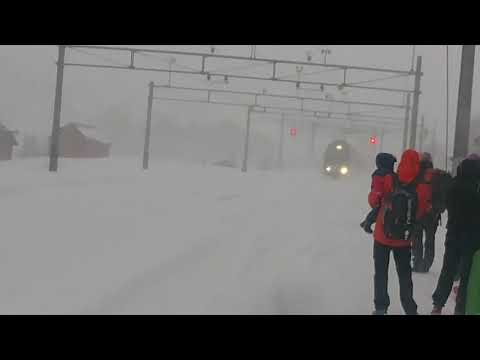 Train plows through snow during snowstorm in Norway