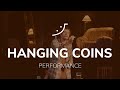 Hanging Coins. Performance by Mario López