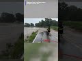 A wild rescue: firefighter pulls a fawn from fast-moving floodwaters in Indiana.