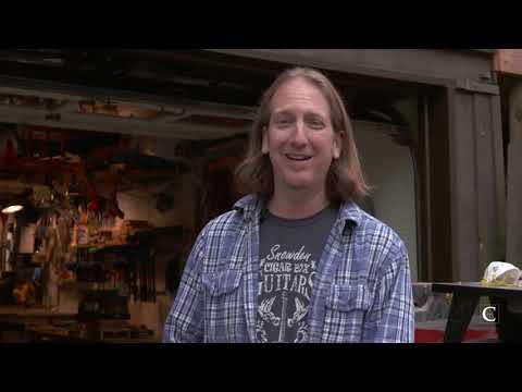 Mike Snowden builds and plays a cigar box guitar