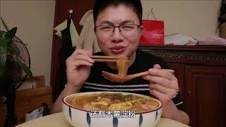 Two packs of wide noodles, cooked with hot pot base and milk, taste chewy, spicy and smooth